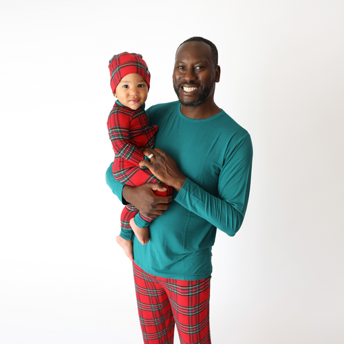 Dad and baby in matching holiday pajamas