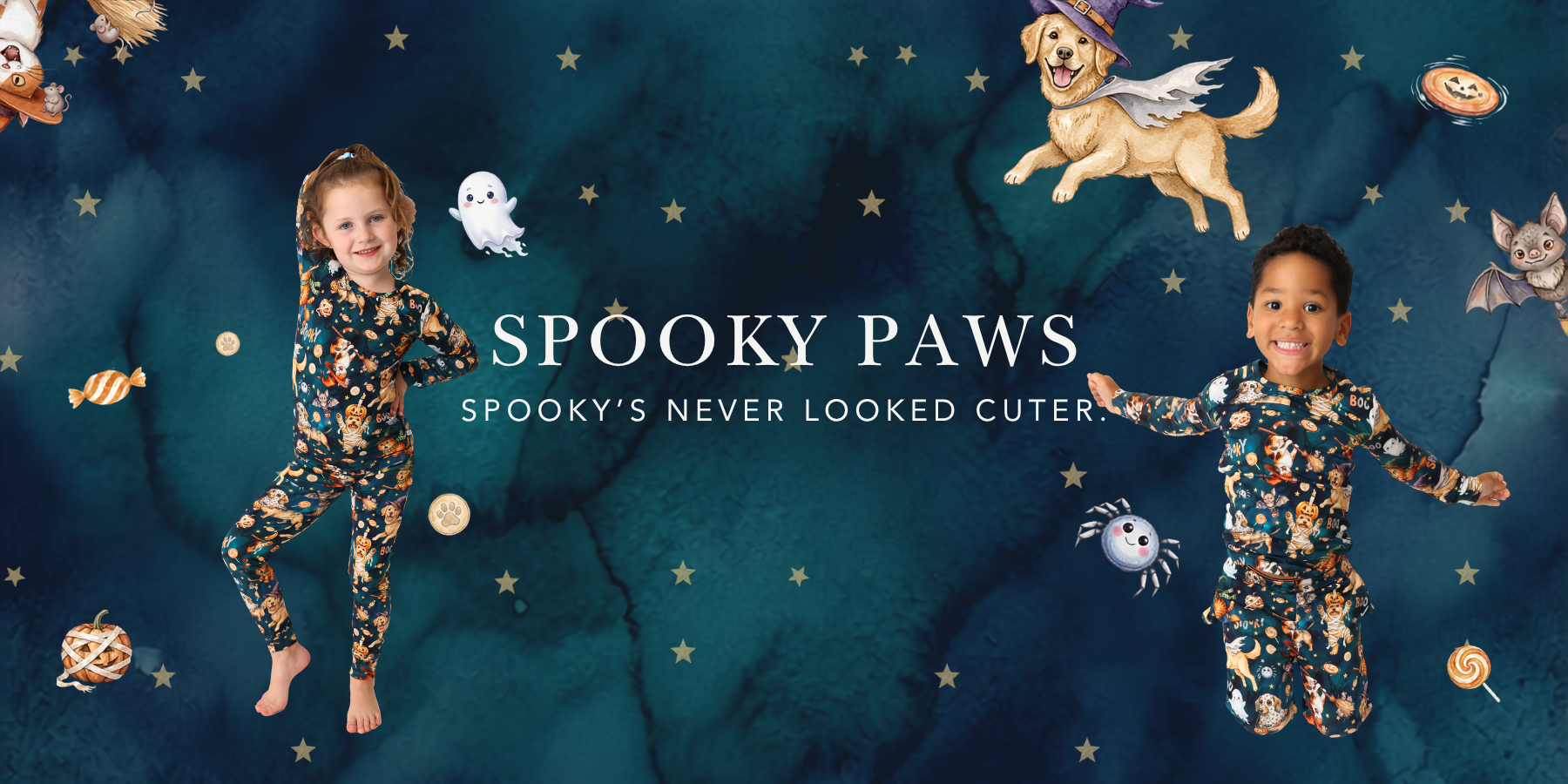 Spooky Paws. Spooky's never looked cuter. Two children in Halloween dog print bamboo pajama sets on a navy watercolor background.